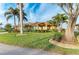 Single-story home with landscaped yard, palm trees, and a paved driveway at 2358 El Cerito Ct, Punta Gorda, FL 33950