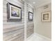 Hallway with wood-like wall accents and framed artwork at 2358 El Cerito Ct, Punta Gorda, FL 33950