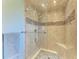 Elegant shower with glass enclosure, tiled walls, and built-in seat at 2358 El Cerito Ct, Punta Gorda, FL 33950