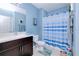 Clean bathroom with dark vanity, shower, and striped curtain at 25281 E Lenox Cir, Punta Gorda, FL 33950