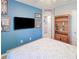 Blue-themed bedroom with a full-size bed, TV and wall decor at 25281 E Lenox Cir, Punta Gorda, FL 33950