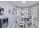 Bright dining room features a round wooden table with white chairs and a wine cooler at 25281 E Lenox Cir, Punta Gorda, FL 33950