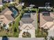 Aerial view of three waterfront homes with private pools and boat docks at 2748 Saint Thomas Dr, Punta Gorda, FL 33950