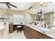 Elegant bathroom with double vanity, granite counters, and a large glass block window at 2748 Saint Thomas Dr, Punta Gorda, FL 33950