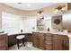 Double vanity bathroom with granite countertop and glass block window at 2748 Saint Thomas Dr, Punta Gorda, FL 33950