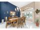 Elegant dining room with a large table, chandelier, and blue accent wall at 2748 Saint Thomas Dr, Punta Gorda, FL 33950