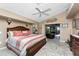 King-size bed, ceiling fan, and access to the patio at 2748 Saint Thomas Dr, Punta Gorda, FL 33950