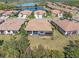 Aerial view of a home in a lakeside community, with lush landscaping, and tranquil water views at 2860 Arugula Dr, North Port, FL 34289