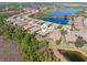 Drone shot of house location, with an aerial view of a lakeside community, lush landscaping, and water views at 2860 Arugula Dr, North Port, FL 34289