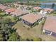 Aerial view of a screened-in lanai overlooking lush landscaping in this lakeside community at 2860 Arugula Dr, North Port, FL 34289