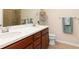 Bathroom featuring double vanity, wood cabinets, and a glass-door shower at 2860 Arugula Dr, North Port, FL 34289