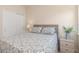 Bedroom with a queen sized bed, soft neutral colors, and a sliding door closet at 2860 Arugula Dr, North Port, FL 34289