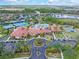 Aerial view of community center with pool, tennis courts, pickle ball, and event green at 2860 Arugula Dr, North Port, FL 34289