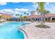 Spacious community pool area with ample seating and lush landscaping at 2860 Arugula Dr, North Port, FL 34289