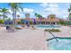 Resort-style pool with lounge seating, umbrellas, and lush landscaping at 2860 Arugula Dr, North Port, FL 34289