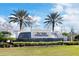 Del Webb Cypress Falls entrance featuring a water feature and lush landscaping at 2860 Arugula Dr, North Port, FL 34289