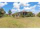 Screened-in lanai exterior, surrounded by well-maintained landscaping and lush lawn at 2860 Arugula Dr, North Port, FL 34289