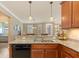 Granite countertops and wooden cabinetry in a kitchen overlooking an open floor plan at 2860 Arugula Dr, North Port, FL 34289