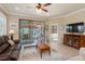 Bright living room with neutral walls, tile floors, and sliders to the covered lanai at 2860 Arugula Dr, North Port, FL 34289