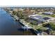 Aerial view showcasing canal-front property, boat dock, and large backyard at 2871 Coral Way, Punta Gorda, FL 33950
