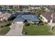 Aerial view of a single-Gathering home with a paved driveway and grassy lawn at 2871 Coral Way, Punta Gorda, FL 33950