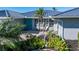 Teal front door, paver patio, and lush landscaping at 2871 Coral Way, Punta Gorda, FL 33950