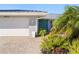 White garage door, teal front door and paved driveway at 2871 Coral Way, Punta Gorda, FL 33950