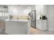 Modern kitchen with white cabinets, stainless steel appliances, and a kitchen island at 2871 Coral Way, Punta Gorda, FL 33950