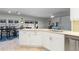 Modern white kitchen with stainless steel appliances and island at 2871 Coral Way, Punta Gorda, FL 33950