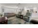 Living room with a sofa, two armchairs, and a view into the kitchen at 2871 Coral Way, Punta Gorda, FL 33950