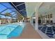 Relaxing pool area with covered patio, comfortable seating, and water views at 2871 Coral Way, Punta Gorda, FL 33950