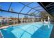 Expansive pool with screened enclosure overlooking canal at 2871 Coral Way, Punta Gorda, FL 33950