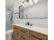 Modern bathroom with light wood vanity,quartz countertop and a large mirror at 3429 Sleepy Hollow Ln, Punta Gorda, FL 33950