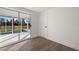 Bedroom with wood-look floors and sliding doors to lanai at 3429 Sleepy Hollow Ln, Punta Gorda, FL 33950