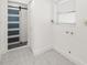 Bright laundry room with tile flooring and a modern sliding barn door at 3429 Sleepy Hollow Ln, Punta Gorda, FL 33950