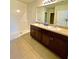 Bathroom boasts dual sinks, large vanity, and a shower at 3924 Candia Ave, North Port, FL 34286