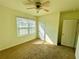 Well-lit bedroom with carpet flooring, a ceiling fan, and ample natural light at 3924 Candia Ave, North Port, FL 34286