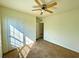 Spacious bedroom with carpet, ceiling fan, and a large window at 3924 Candia Ave, North Port, FL 34286