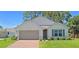 Craftsman style home with a taupe garage door and green shutters at 3924 Candia Ave, North Port, FL 34286