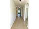 Bright hallway with tile flooring and arched doorways leading to other rooms at 3924 Candia Ave, North Port, FL 34286