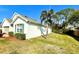 Side view of the house with landscaping and palm tree at 3924 Candia Ave, North Port, FL 34286