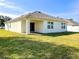 Back of house with covered patio and grassy backyard at 3924 Candia Ave, North Port, FL 34286