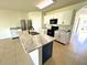 Island kitchen with white cabinets and marble countertops at 3924 Candia Ave, North Port, FL 34286