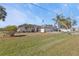 Single-story home with a two-car garage and lush landscaping at 413 San Ambrosio St, Punta Gorda, FL 33983