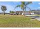 Single-story house with a two-car garage and palm trees at 413 San Ambrosio St, Punta Gorda, FL 33983