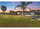 Single-story home with a two-car garage,palm trees and sunset view at 413 San Ambrosio St, Punta Gorda, FL 33983