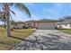 Single-story house with a two-car garage and palm trees at 413 San Ambrosio St, Punta Gorda, FL 33983