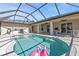 Large screened pool with patio furniture and grill at 413 San Ambrosio St, Punta Gorda, FL 33983