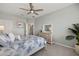 Guest bedroom with a queen-size bed, dresser, and ceiling fan at 43306 Water Bird Way # 6622, Punta Gorda, FL 33982