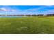 Stunning golf course view with lake and residential buildings in background at 43306 Water Bird Way # 6622, Punta Gorda, FL 33982